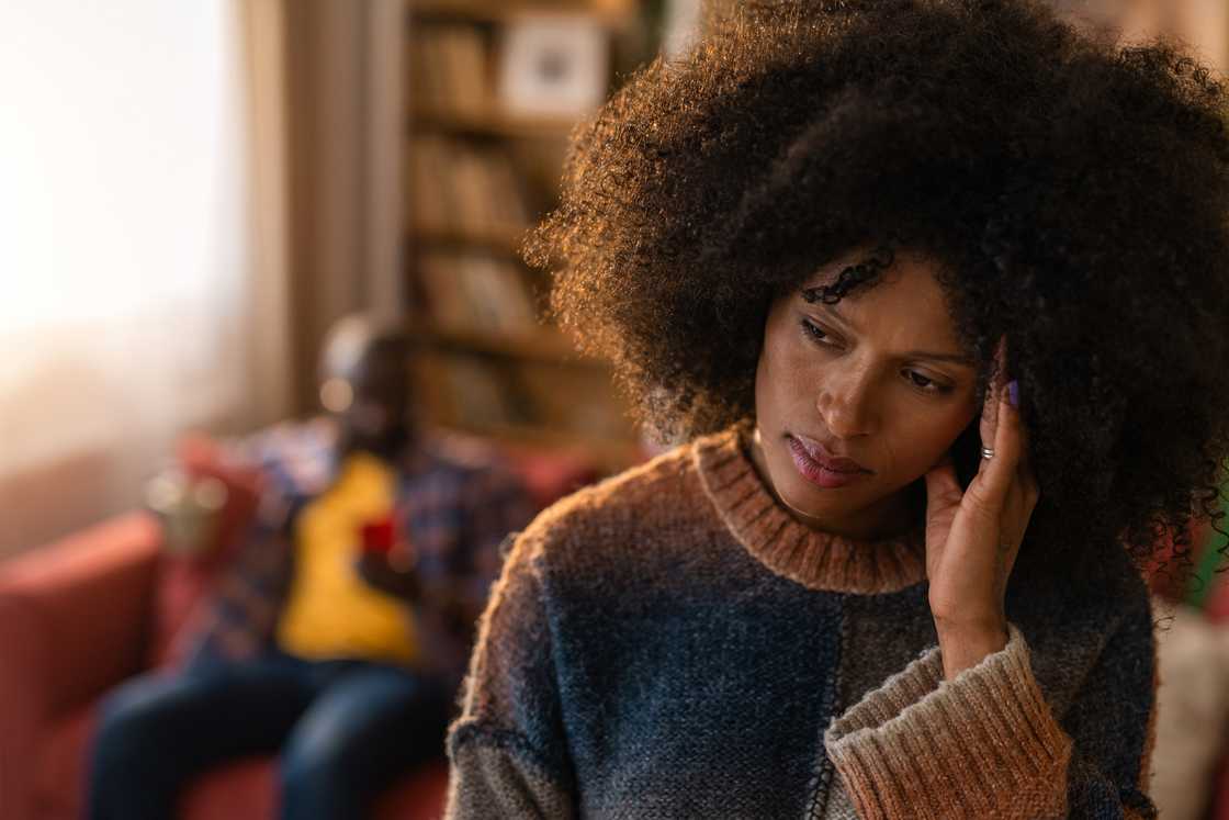 A woman having an argument with her boyfriend sitting A woman having an argument with her boyfriend sitting