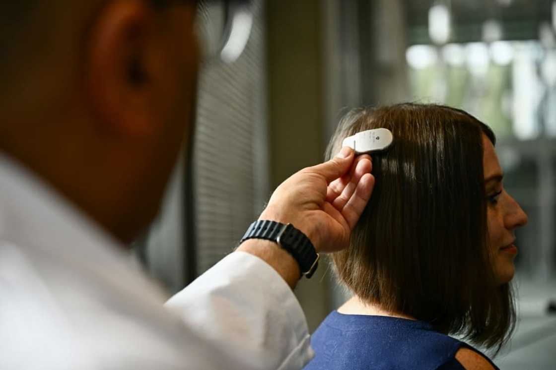 Dr. Ahmed Raslan, professor of neurological surgery, demonstrates the placement of a brain implant for patient Amber Pearson Dr. Ahmed Raslan, professor of neurological surgery, demonstrates the placement of a brain implant for patient Amber Pearson