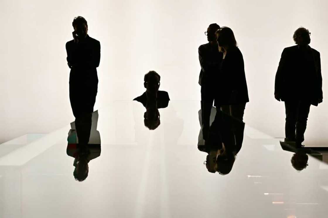 Visitors look at a glass table by Italian brand Santambrogiomila Visitors look at a glass table by Italian brand Santambrogiomila