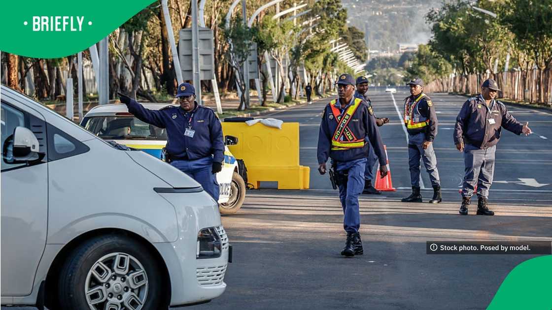 South African Police Service (SAPS) officers direct traffic South African Police Service (SAPS) officers direct traffic