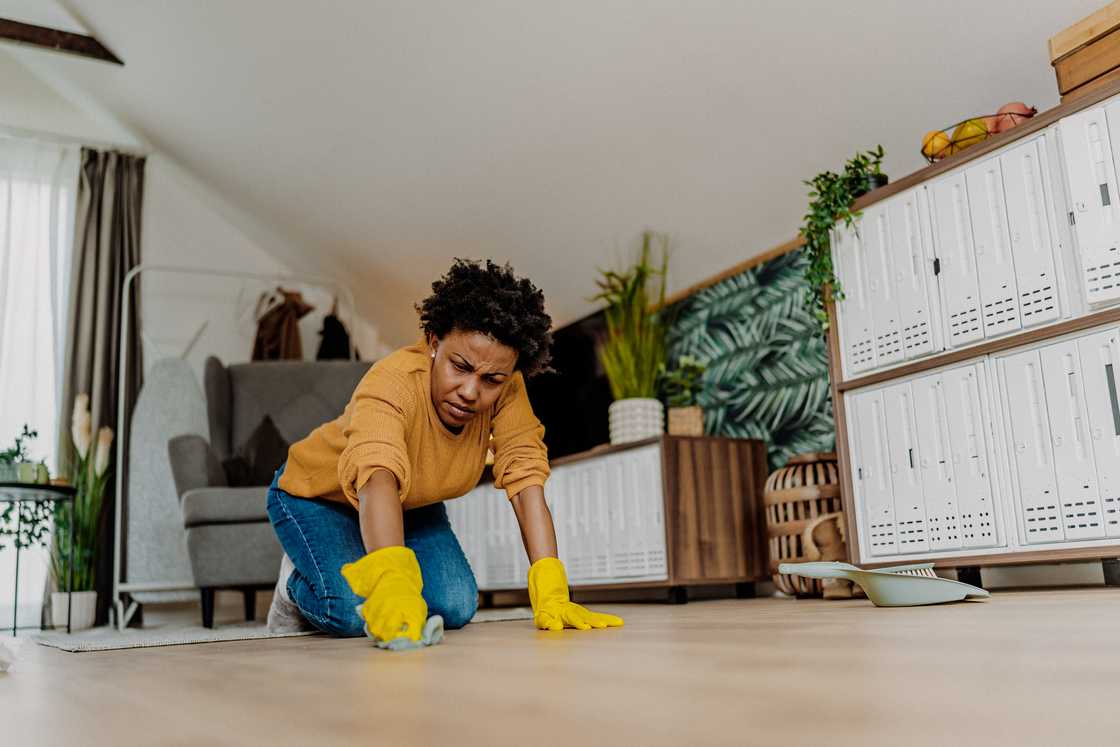 Mid adult woman cleaning floor Mid adult woman cleaning floor