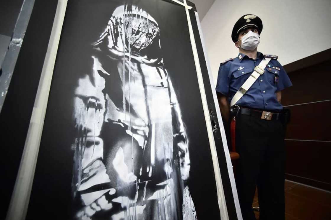 British street artist Banksy painted his 'sad girl' stencil on the metal door of the Bataclan