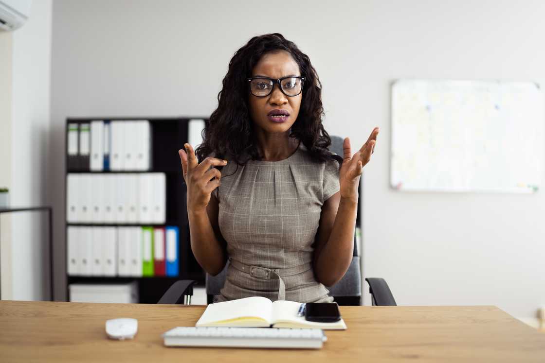A lady in her office explaining something A lady in her office explaining something