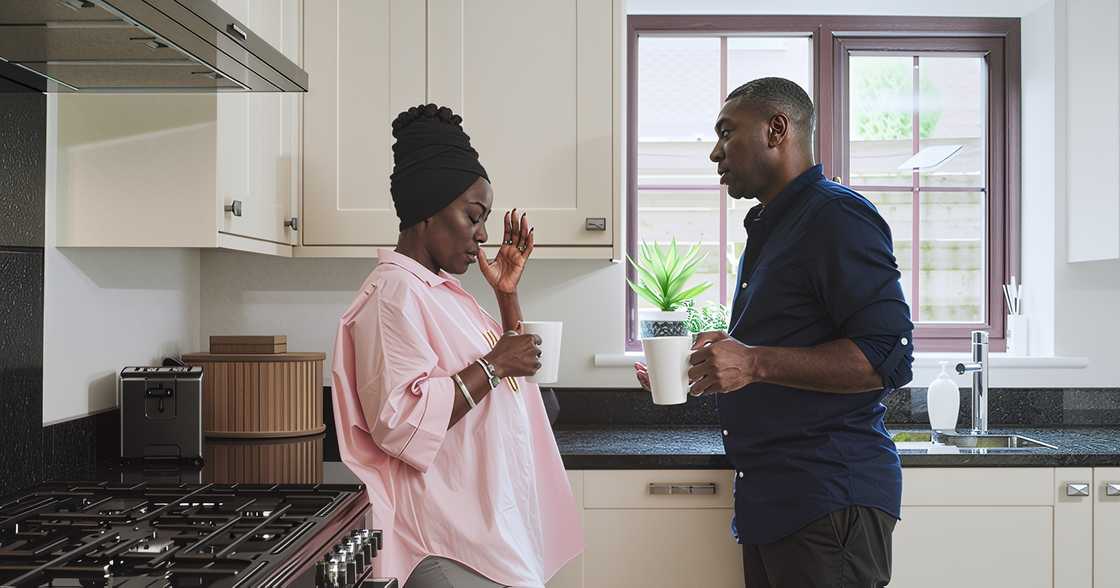 A black couple in a kitchen argues A black couple in a kitchen argues