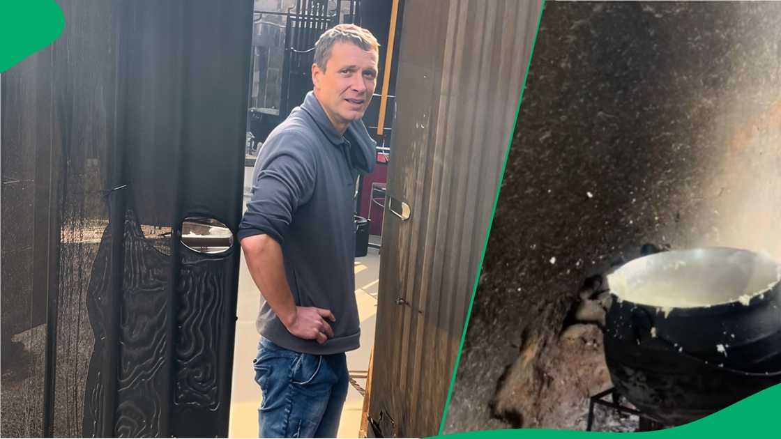 Man cooks pap over fire in large pot Man cooks pap over fire in large pot