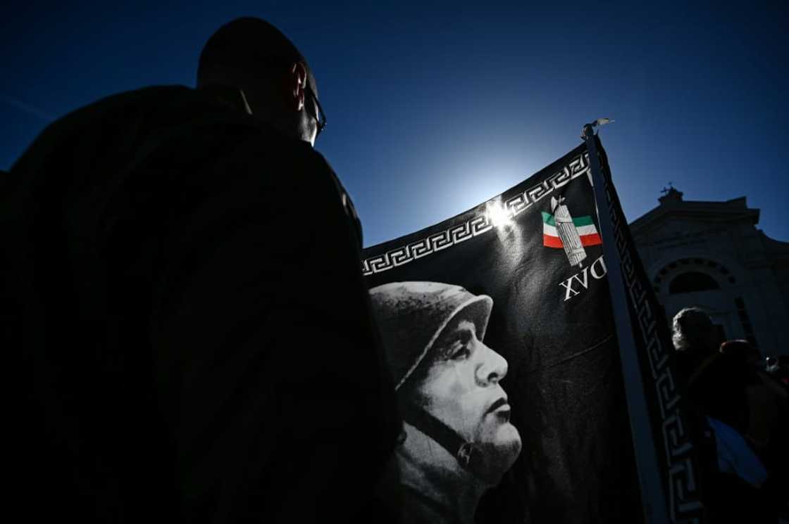 A participant holds a flag during a rally marking the centenary of the March on Rome which ushered in fascism