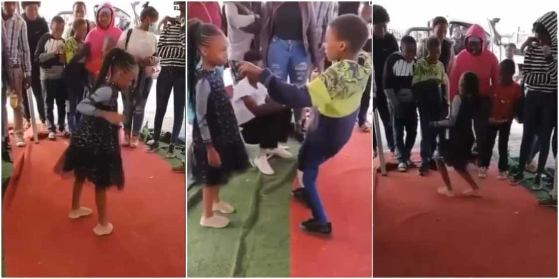 A boy and a girl engaged in a dancing competition A boy and a girl engaged in a dancing competition