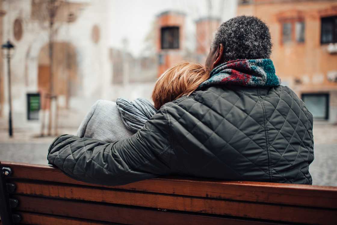 An elderly couple on a bench.