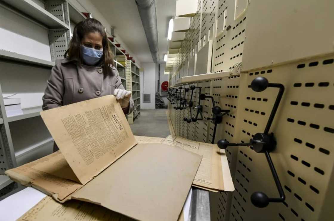 An employee at the National Library of Tunisia leafs through old newspapers An employee at the National Library of Tunisia leafs through old newspapers