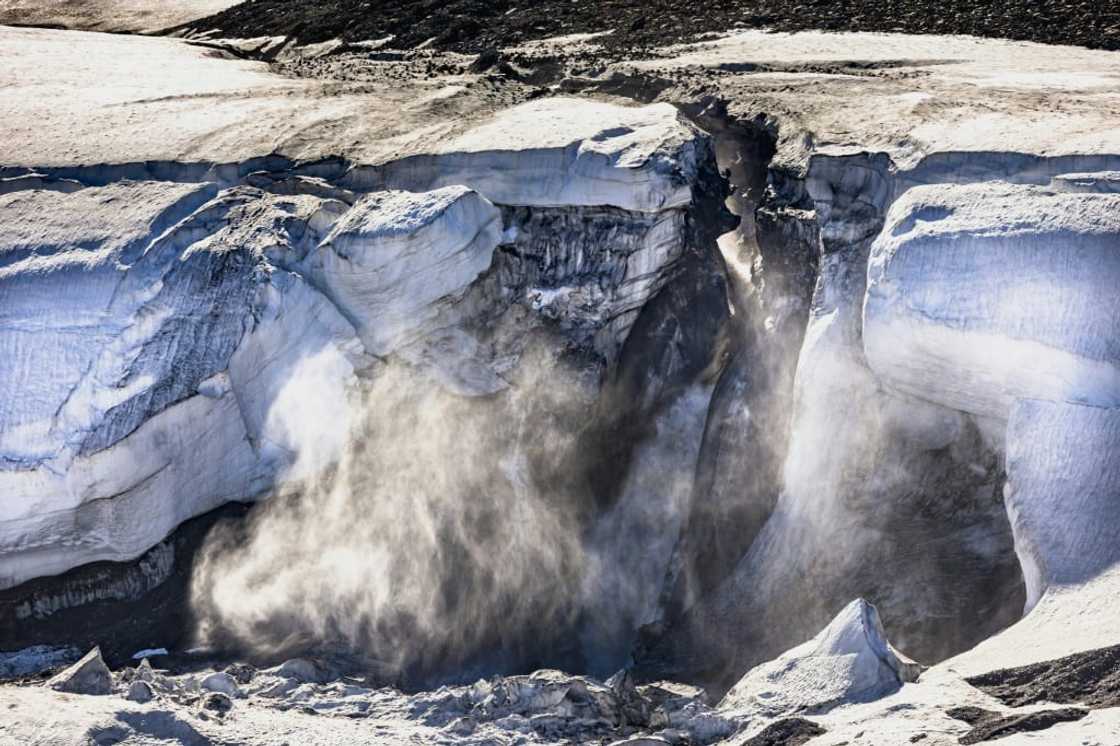 In this file photo taken on July 17, 2022, meltwater flows from the Greenland ice sheet into the Baffin Bay near Pituffik, Greenland