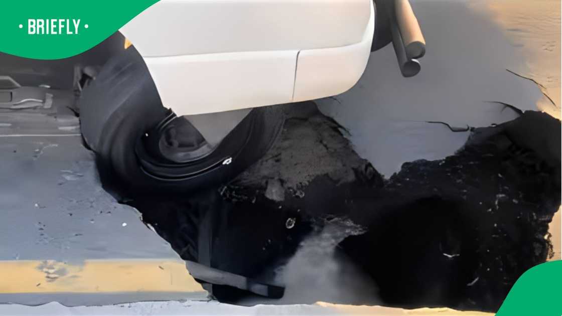 A taxi gets stuck on Delft Main Road sinkhole