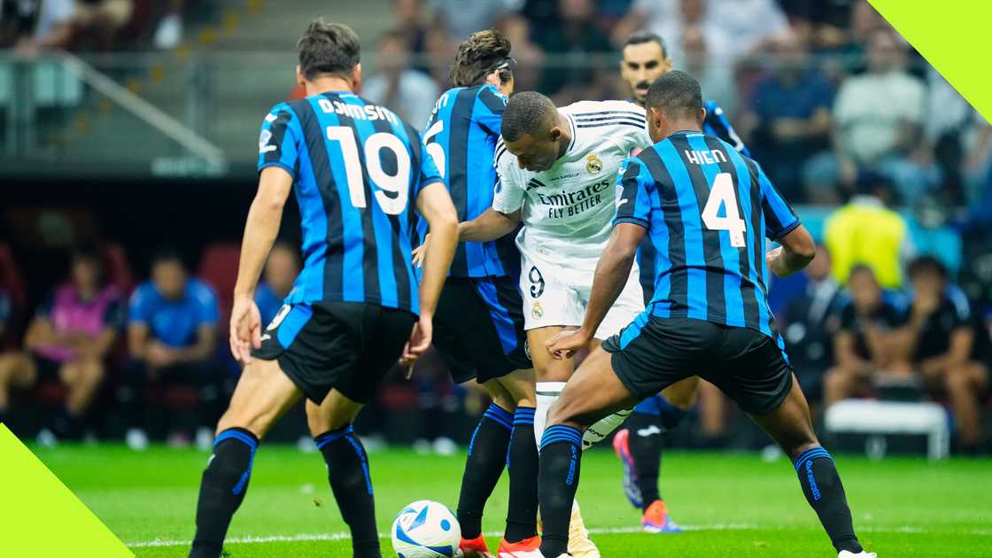 Kylian Mbappe tries to wriggle away from a sea of Atalanta defenders during Real Madrid's UEFA Super Cup triumph in Warsaw, Poland, on August 14, 2024. NurPhoto.