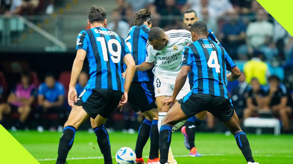 Kylian Mbappe tries to wriggle away from a sea of Atalanta defenders during Real Madrid's UEFA Super Cup triumph in Warsaw, Poland, on August 14, 2024. NurPhoto. Kylian Mbappe tries to wriggle away from a sea of Atalanta defenders during Real Madrid's UEFA Super Cup triumph in Warsaw, Poland, on August 14, 2024. NurPhoto.