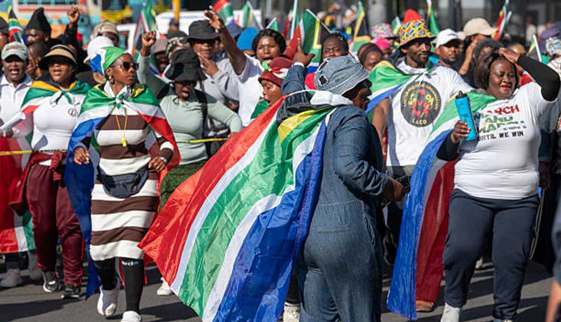 South Africans take part during a march for local empowerment to the Bellville Home Affairs office.