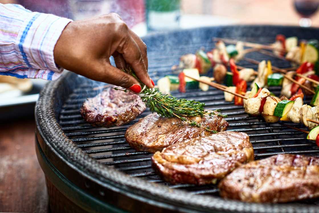 A woman grilling food A woman grilling food