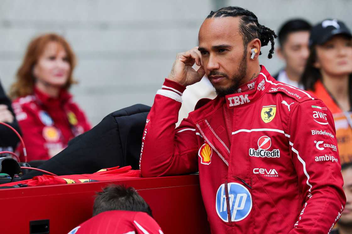 Lewis Hamilton driver for Ferrari and Nomzamo Mbatha was in their garage Lewis Hamilton driver for Ferrari and Nomzamo Mbatha was in their garage