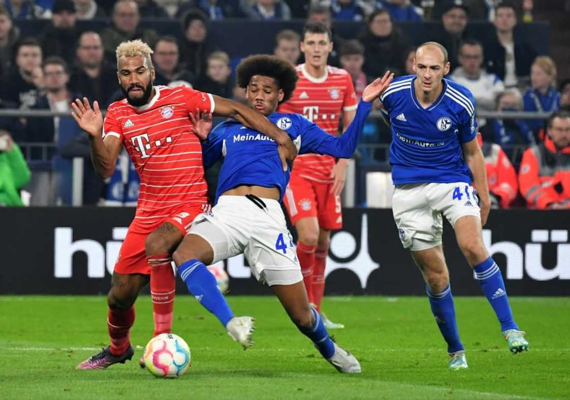 Bayern Munich forward Eric Maxim Choupo-Moting (L) battles for possession in a Bundesliga match against Schalke 04.