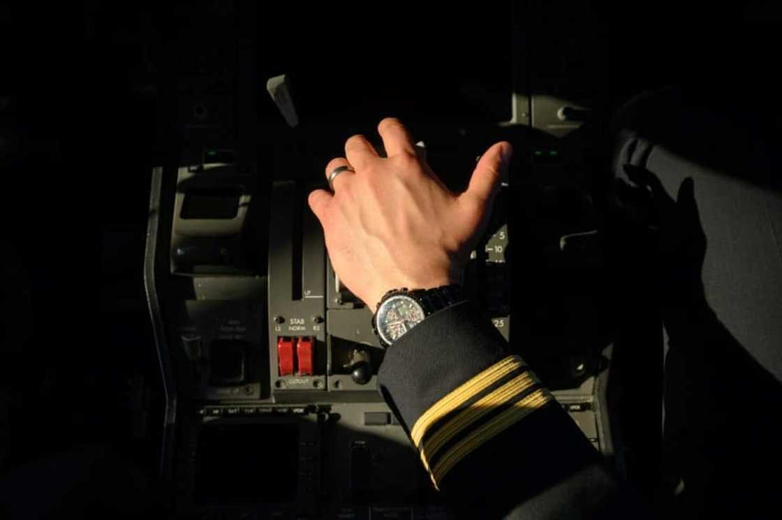 A pilot holds the thrust controls of a United Airlines Boeing 787 aircraft at Newark Liberty International Airport in Newark, New Jersey A pilot holds the thrust controls of a United Airlines Boeing 787 aircraft at Newark Liberty International Airport in Newark, New Jersey