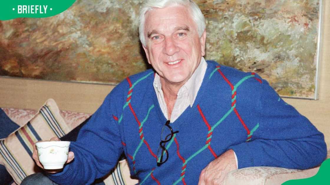 Comedian Leslie Nielsen posing for a photo in 1990