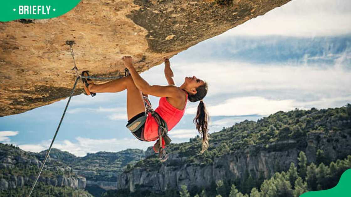 Young woman rock climbing