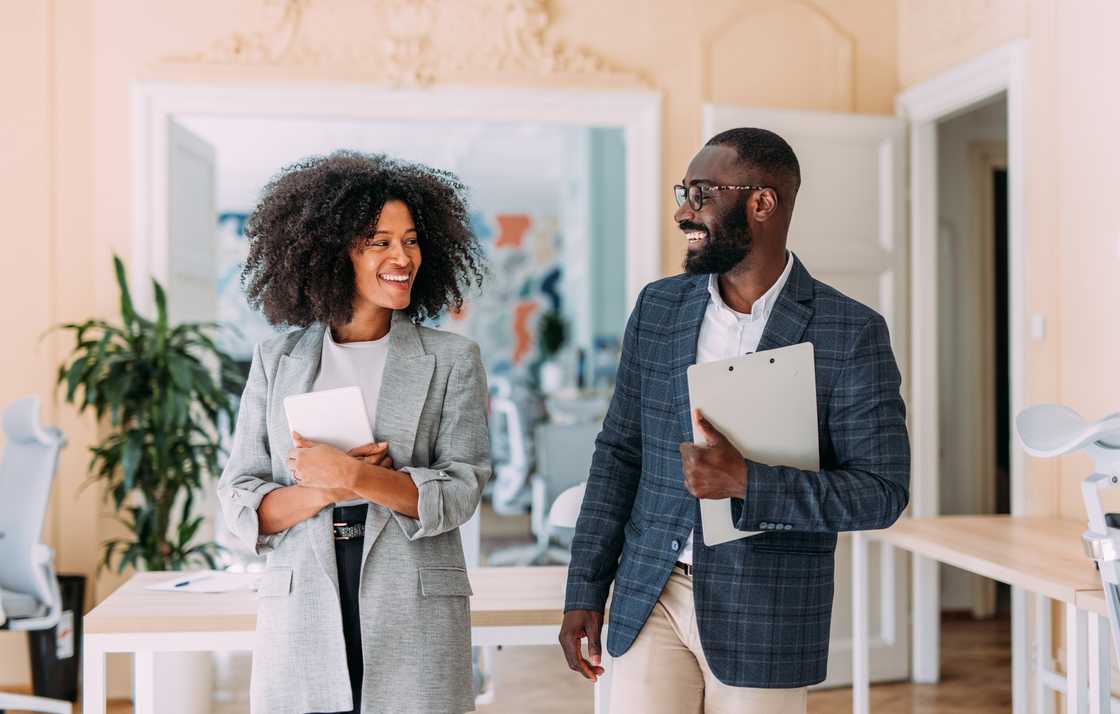 two coworkers having a discussion in a modern office