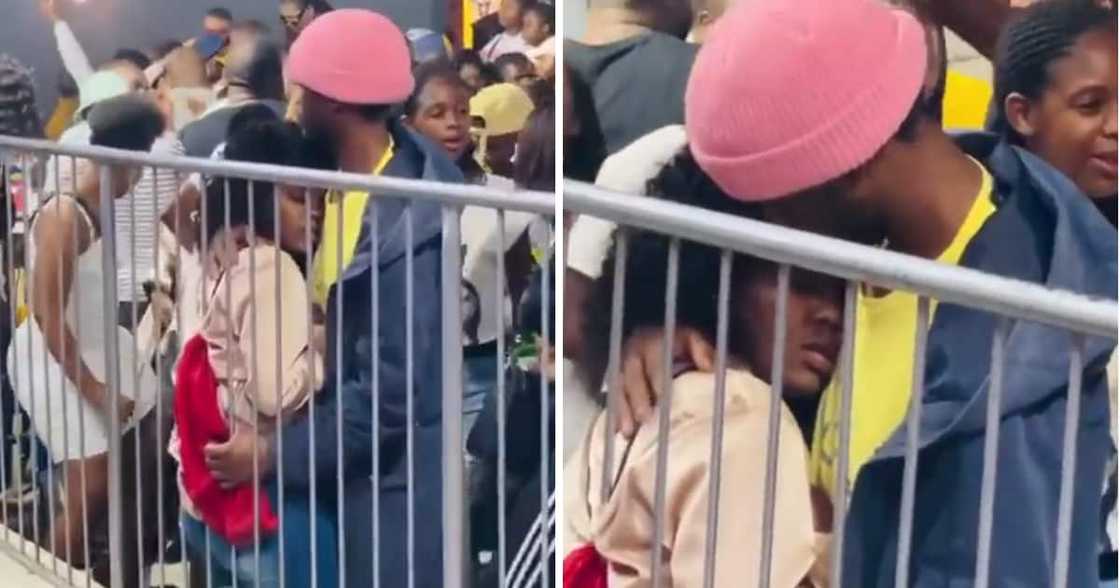A Man comforted a lady at a lit event. A Man comforted a lady at a lit event.