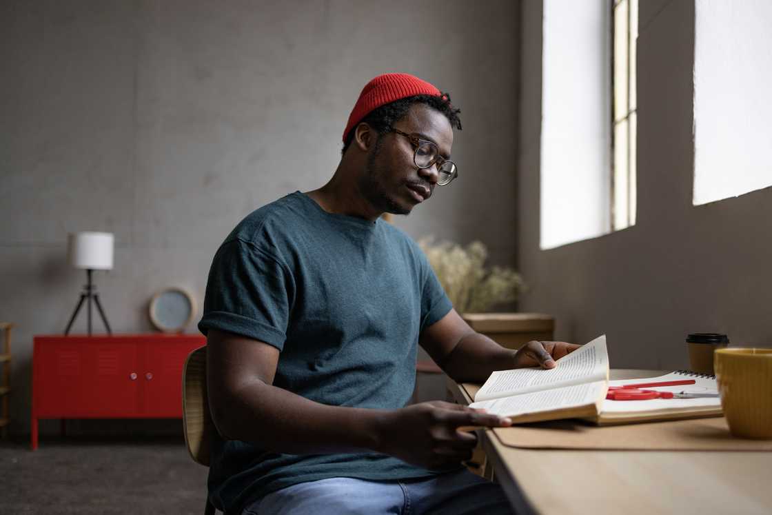 A student reading a book in a hostel
