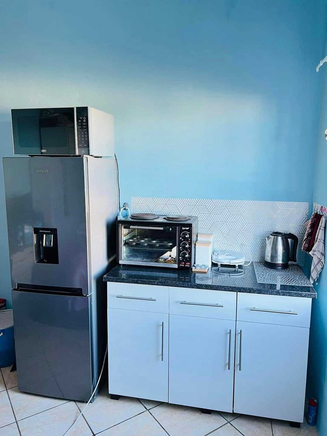 Young student showcases the kitchen space Young student showcases the kitchen space