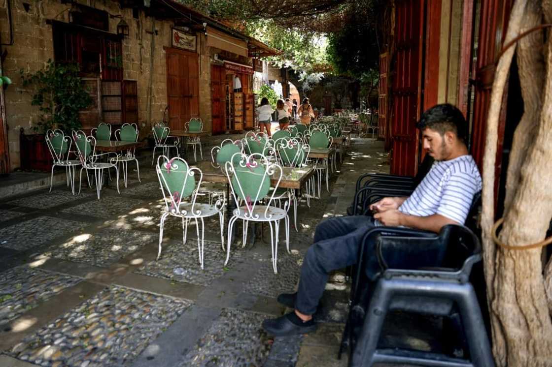 Waiting for customers at an empty restaurant in Lebanon's historic city of Byblos