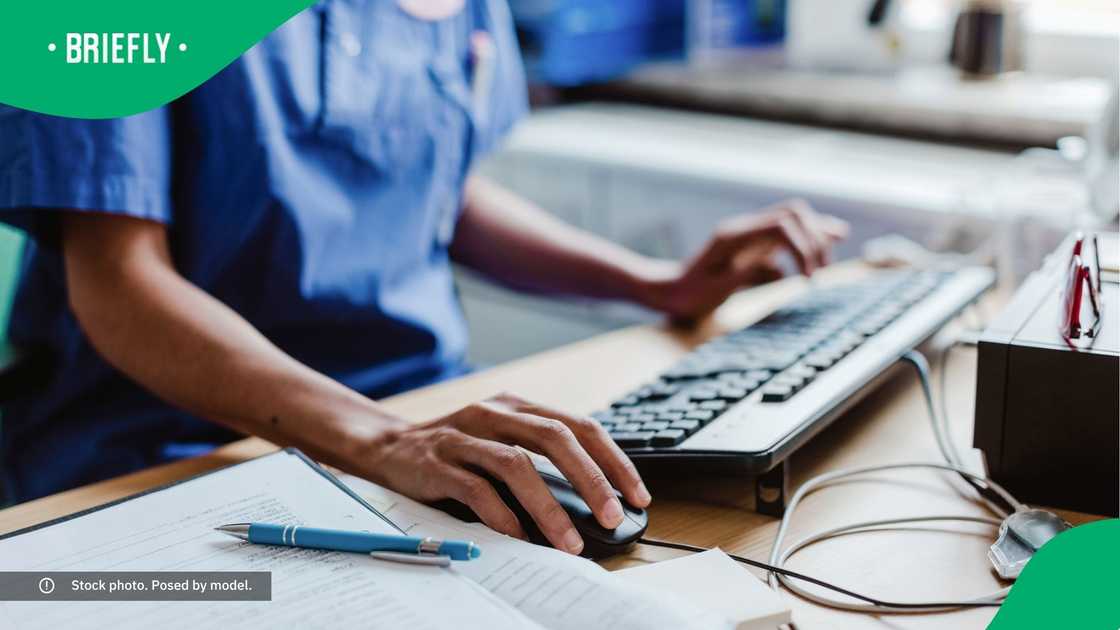 A nurse working at a computer. A nurse working at a computer.