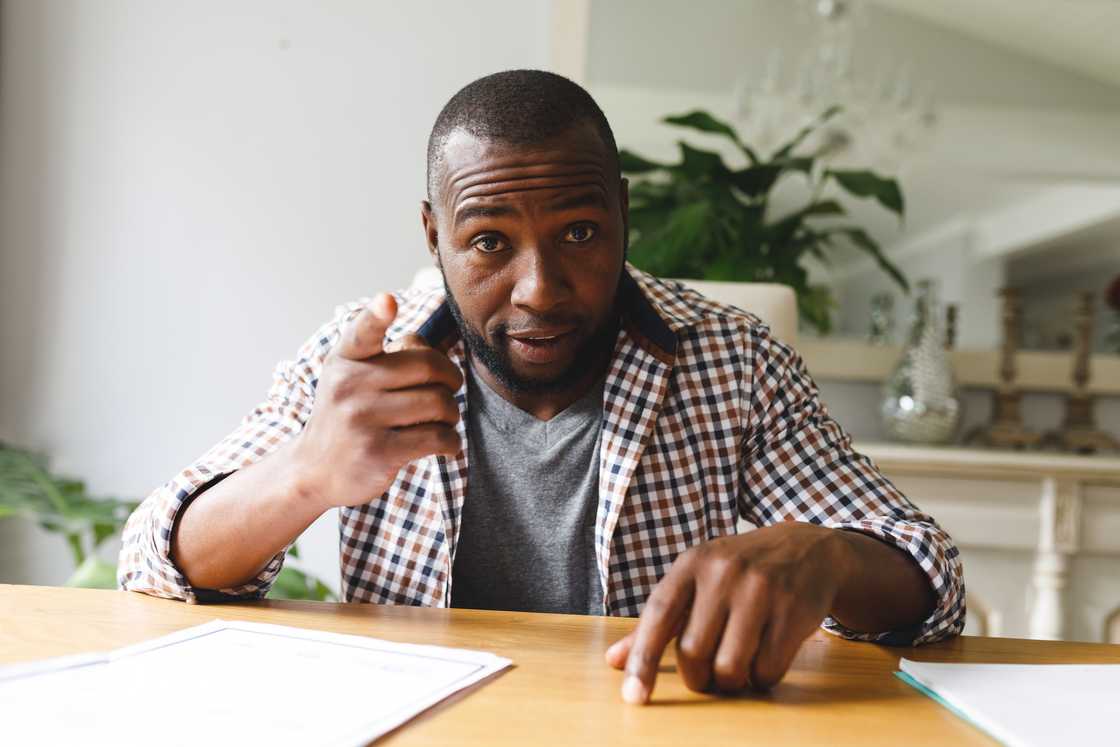 A person slamming hand on kitchen table during tense argument. A person slamming hand on kitchen table during tense argument.