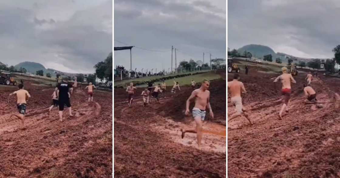 Grown men racing each other around a muddy tarck Grown men racing each other around a muddy tarck