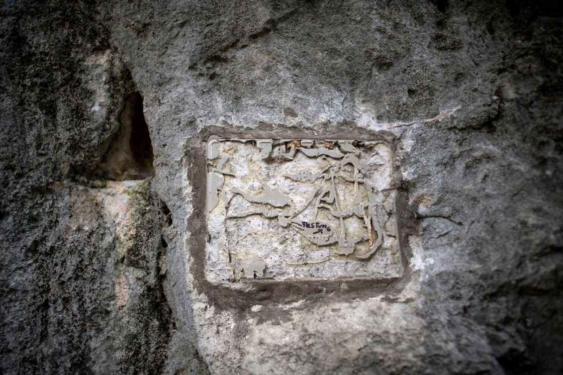 The plaque to victims of 'Fortress Europe' that was torn down at the start of the climb