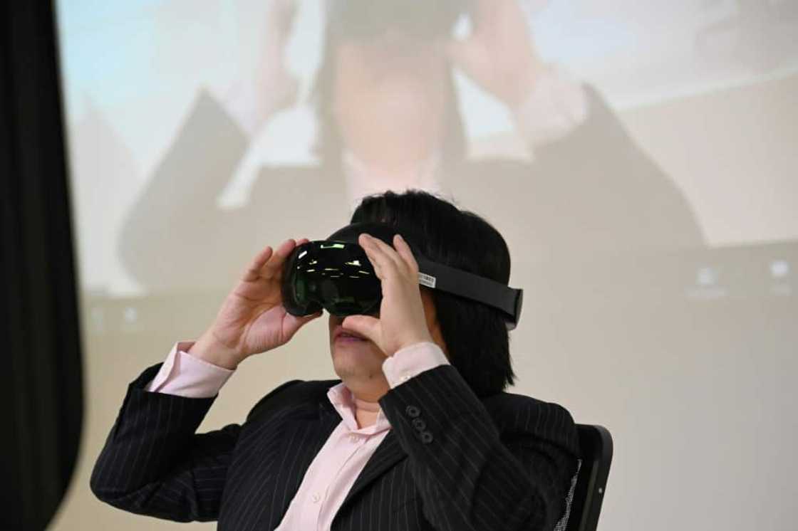 Pan Hui, a professor leading a project on AI education at the Hong Kong University of Science and Technology, slips on a headset Pan Hui, a professor leading a project on AI education at the Hong Kong University of Science and Technology, slips on a headset