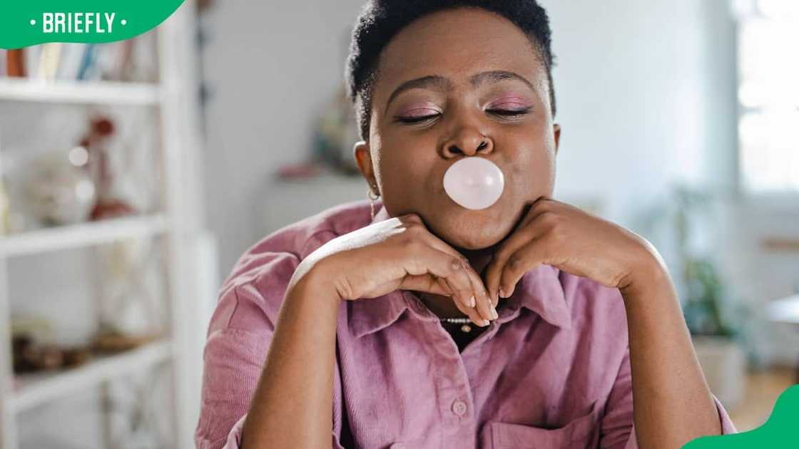 A woman enjoying a bubble gum A woman enjoying a bubble gum