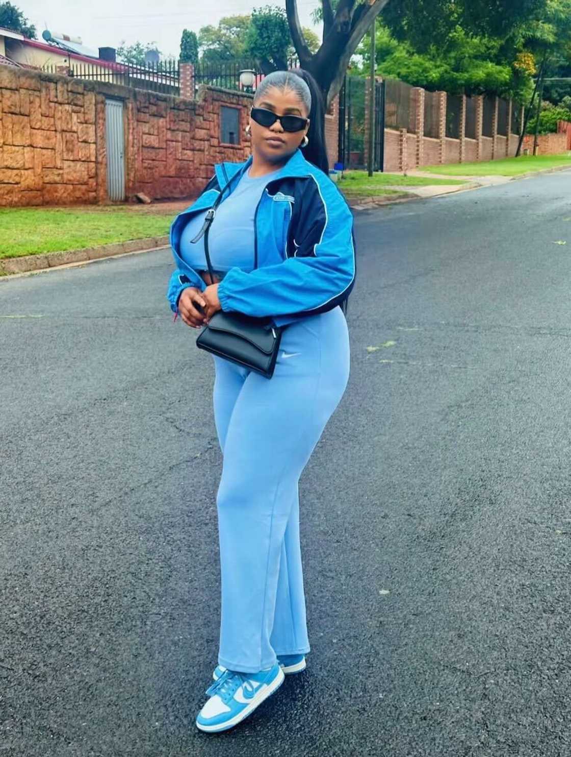 A young woman posed in a TikTok video rocking a blue tracksuit and Nike Air Jordans. A young woman posed in a TikTok video rocking a blue tracksuit and Nike Air Jordans.