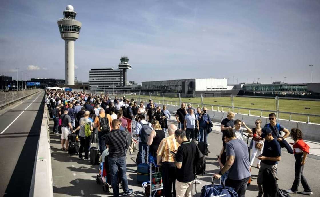 Passengers have had to stand in huge line for hours before catching flights at Amsterdam's Schiphol airport Passengers have had to stand in huge line for hours before catching flights at Amsterdam's Schiphol airport