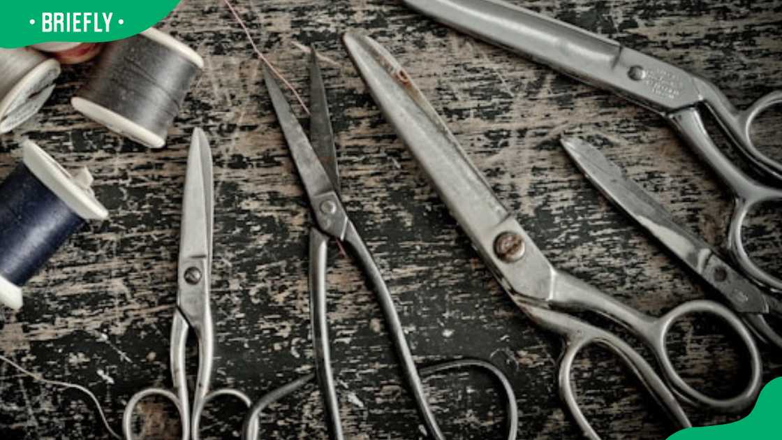 Stainless steel scissors beside thread