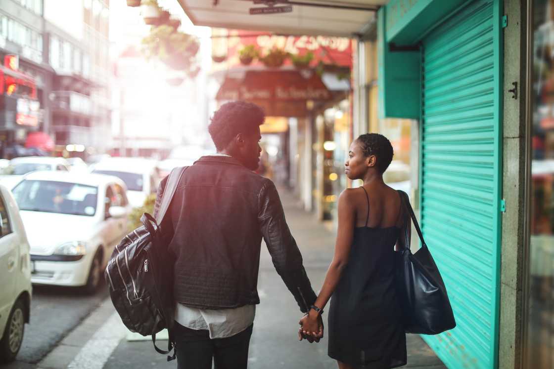 Two love birds pictured on a busy street