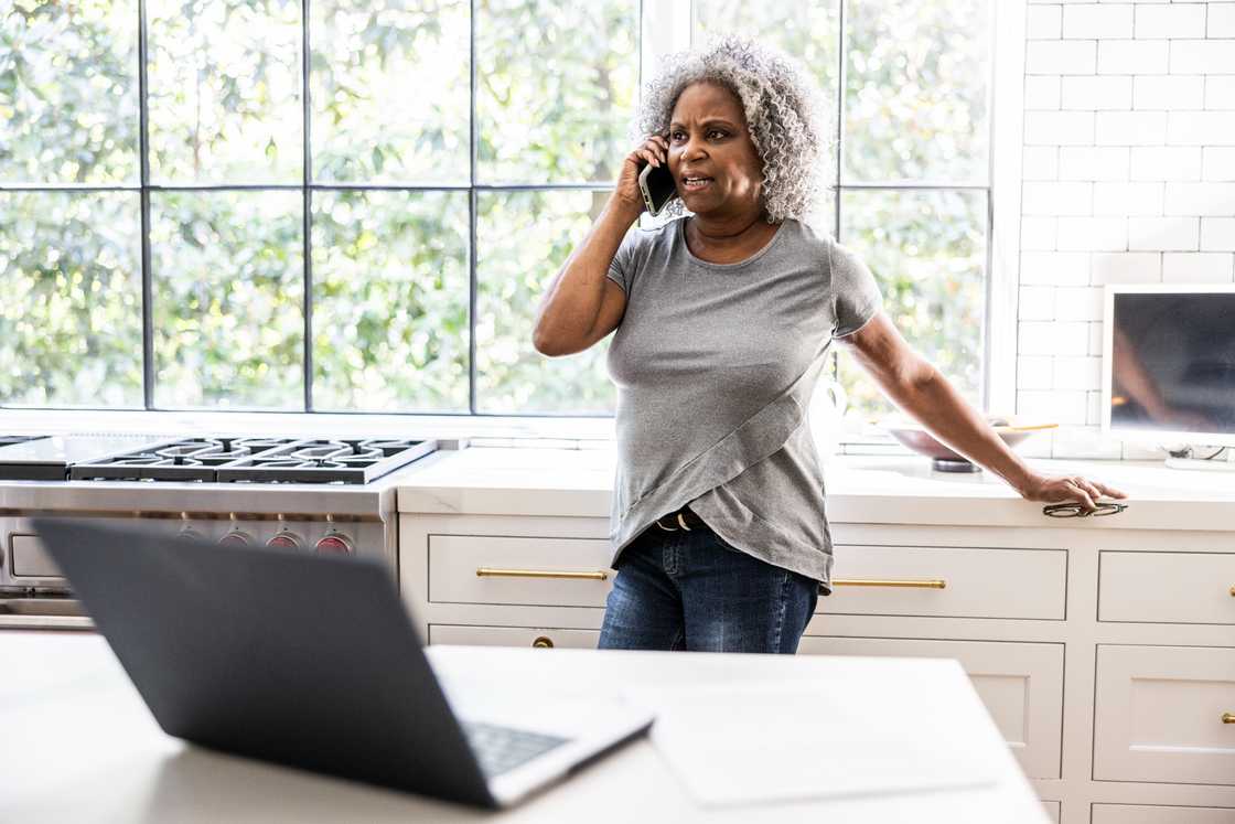 A senior woman is talking on a smartphone A senior woman is talking on a smartphone