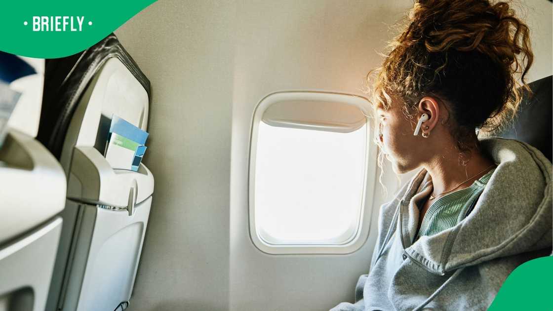 A stock photo of a woman flying on a plane