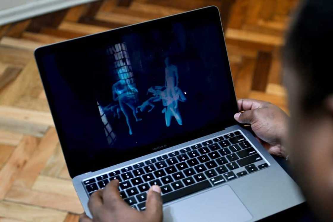 Ex-Venezuelan political prisoner Victor Navarro shows on his laptop part of the virtual reality tour of El Helicoide, a notorious prison in Caracas