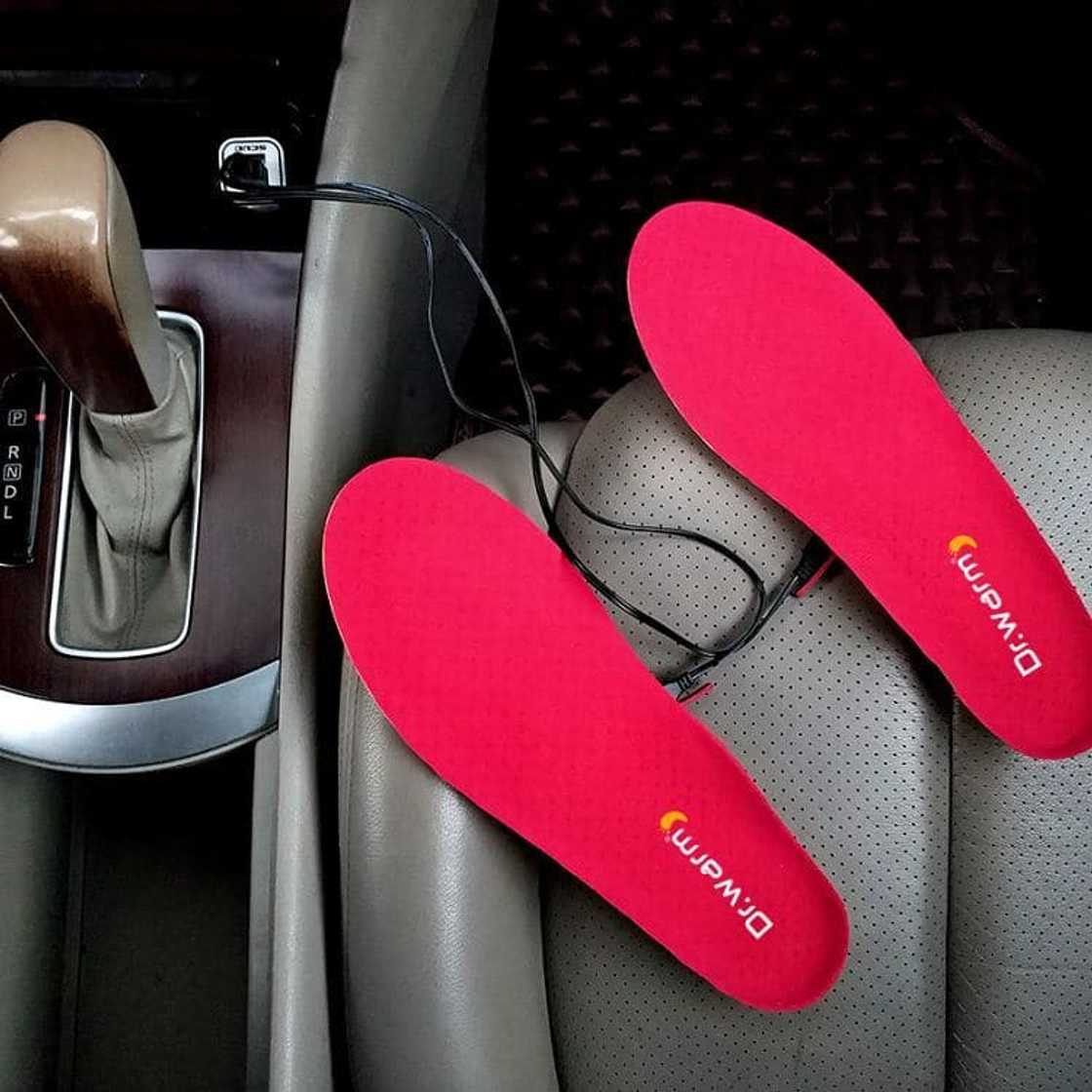 A set of red electric foot warmers on the seat of a car A set of red electric foot warmers on the seat of a car