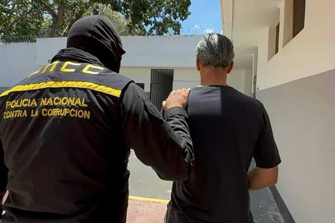 This handout pictured released by the Venezuelan Public Prosecutor's Office on April 9, 2024, shows former Venezuelan oil minister Tareck El Aissami (R) being detained by members of the National Anti-Corruption Police This handout pictured released by the Venezuelan Public Prosecutor's Office on April 9, 2024, shows former Venezuelan oil minister Tareck El Aissami (R) being detained by members of the National Anti-Corruption Police