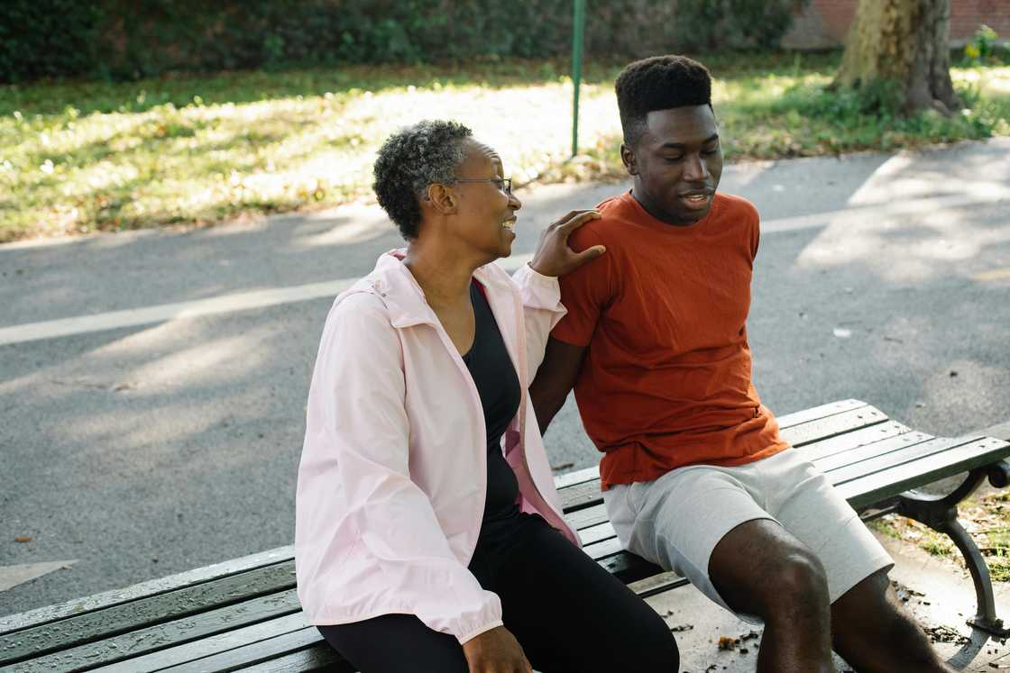 A woman and man sitting on the bench