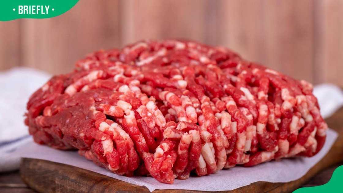 Fresh ground beef on a wood background