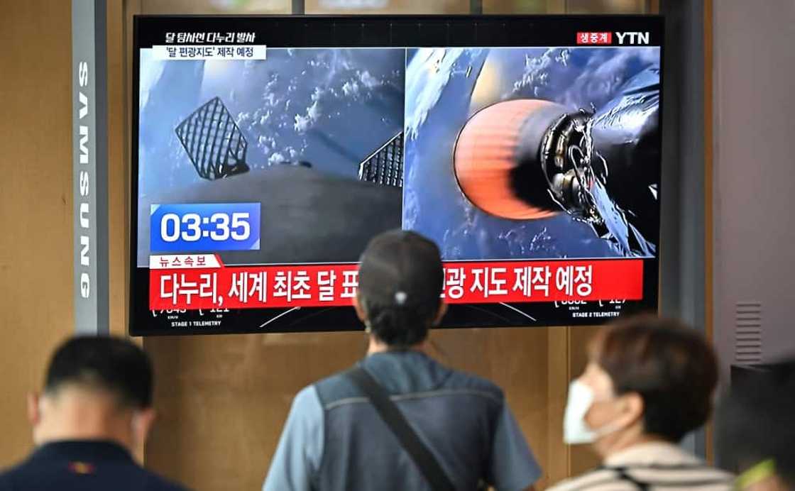 People in a railway station in Seoul watch a television screen showing a SpaceX Falcon 9 rocket launching with South Korea's first lunar orbiter Danuri onboard from Cape Canaveral in Florida People in a railway station in Seoul watch a television screen showing a SpaceX Falcon 9 rocket launching with South Korea's first lunar orbiter Danuri onboard from Cape Canaveral in Florida