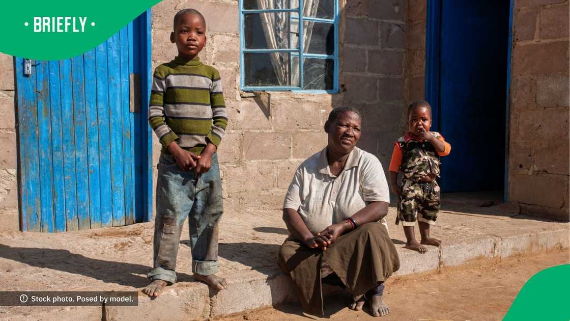 Woman photographed with kids in township Woman photographed with kids in township