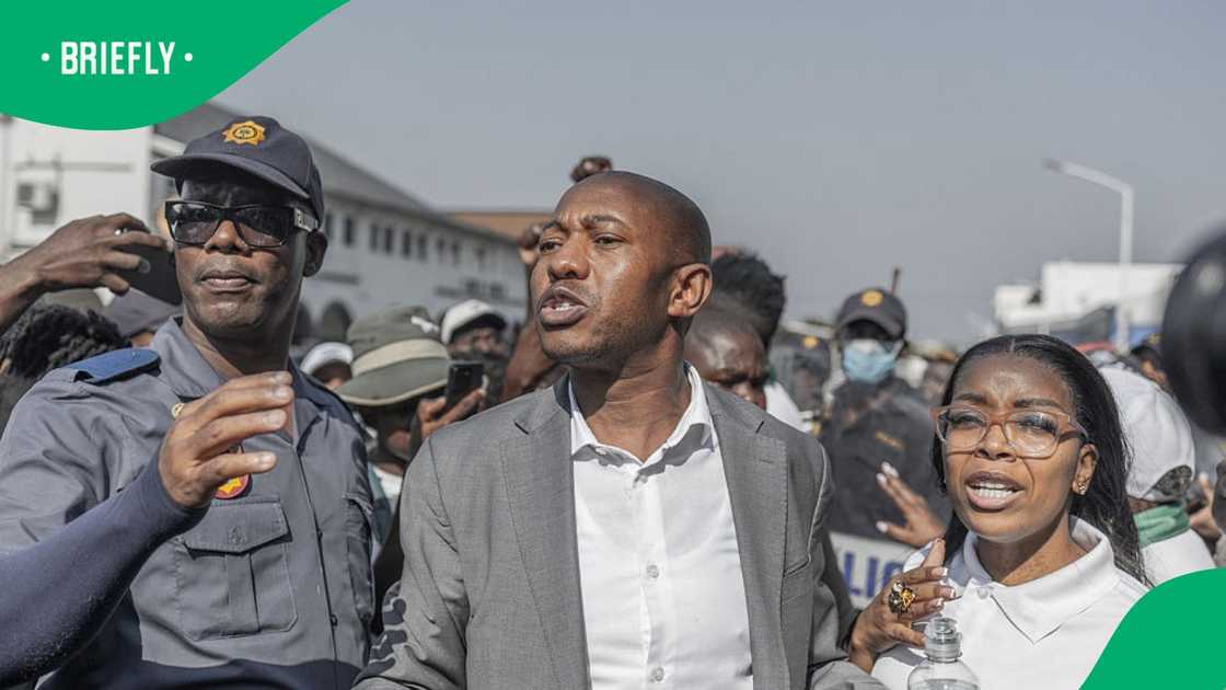 March and March Movement leader Jacinta Ngobese-Zuma and her husband Xolani Zuma stand next to a SAPS officer following clashes between foreign nationals and March and March Movement during a demonstration against undocumented migrants in Durban