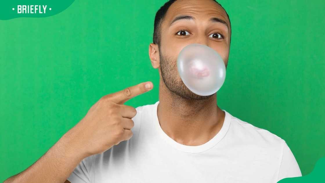 A man pointing to his bubble gum A man pointing to his bubble gum